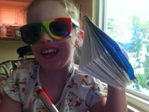 Nora with sunglasses and her sketchbook